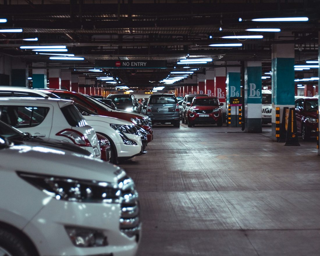 Covered basement parking with rows of SUVs