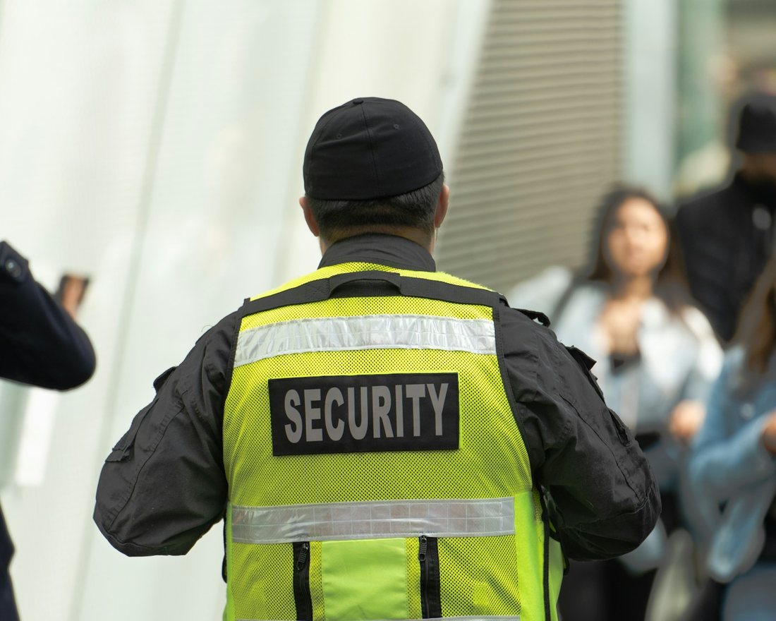 Security guard in a high-visibility vest on duty